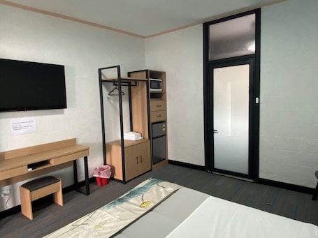 Escritorio, cortinas blackout y tabla de planchar con plancha