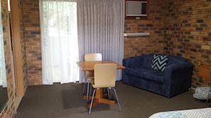 Economy Suite, 1 Queen Bed, Microwave, Ground Floor | Living area | Flat-screen TV