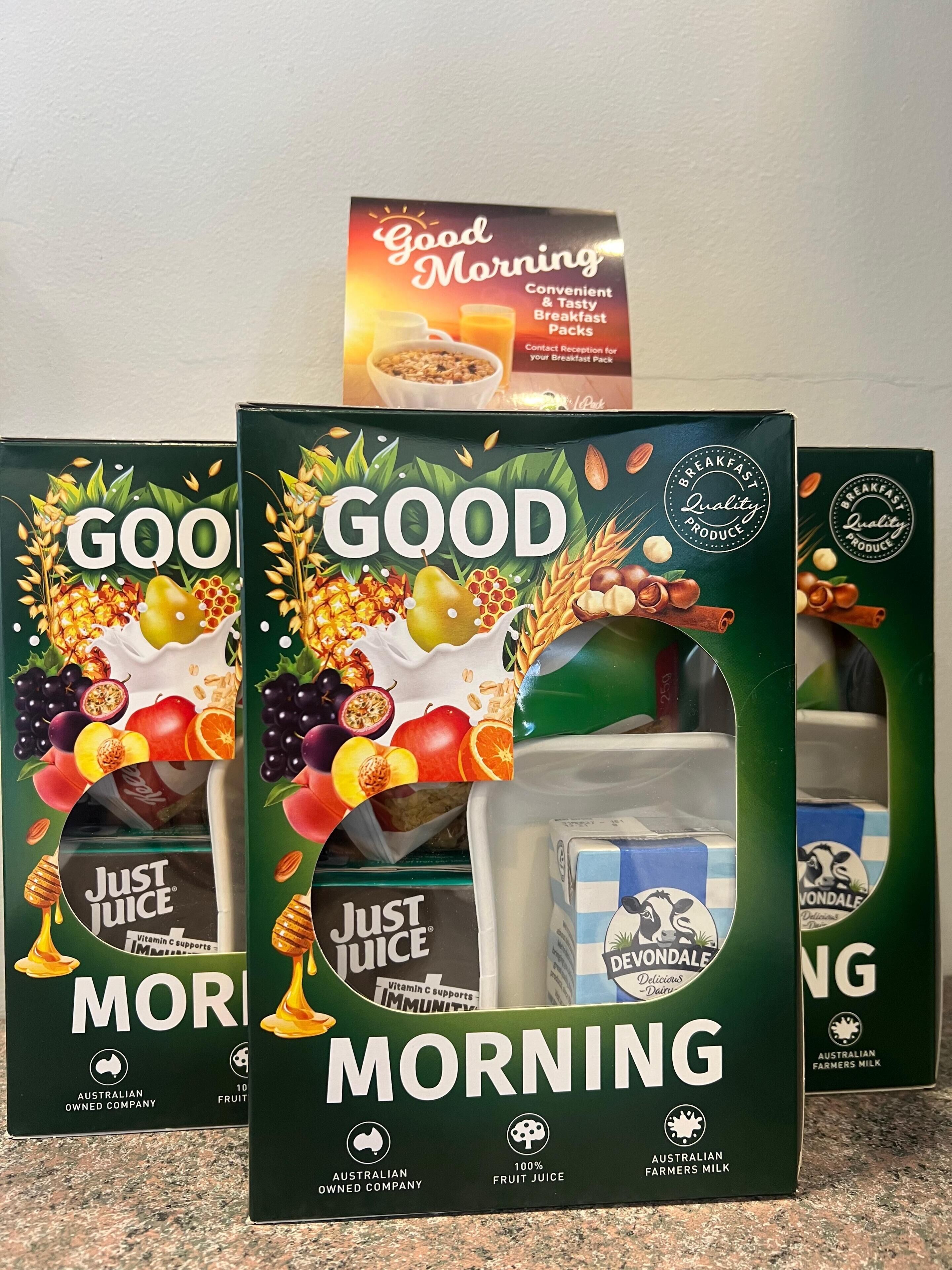 Three boxes of 'GOOD MORNING' breakfast packs with 'Just Juice' and 'Deondale' dairy products.