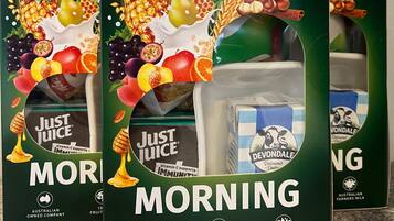 Three boxes of 'GOOD MORNING' breakfast packs with 'Just Juice' and 'Deondale' dairy products.
