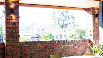Enjoy a view of the outside from the large window in this cozy space with a round table and chairs.
