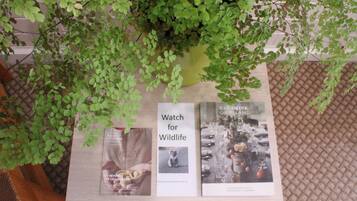 A table with a plant, two books, and a sign that says "Watch for Wildlife".