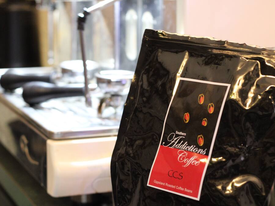 A bag of Southern Addictions Coffee labeled as CCS, with a label indicating it contains Gipsland Roasted Coffee Beans.