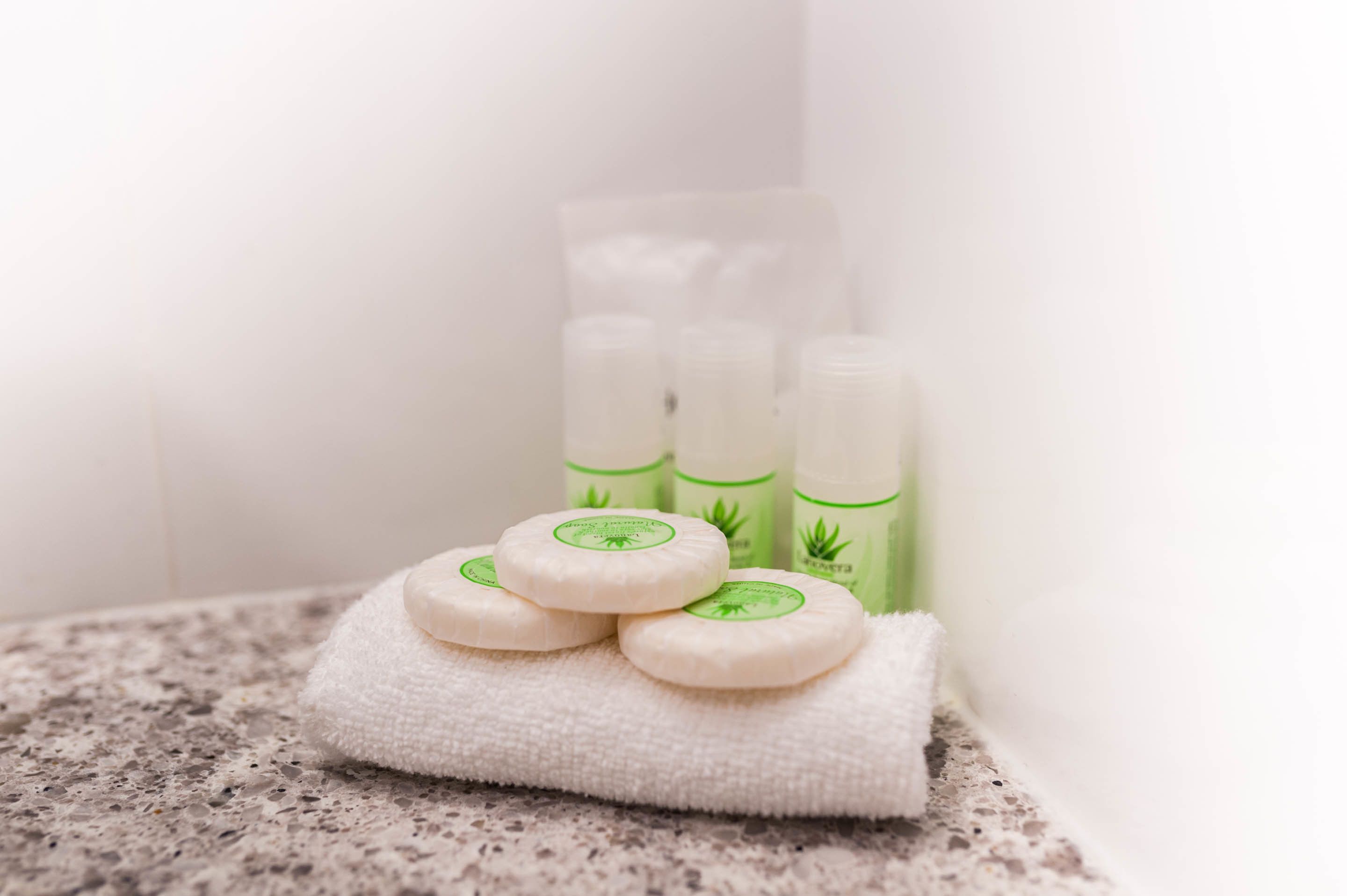 A towel with soap and lotion bottles on a countertop.