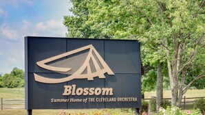 A sign for Blossom, Summer Home of the Cleveland Orchestra, with a logo and text. - Knights Inn Macedonia (Macedonia)