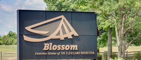 A sign for Blossom, Summer Home of the Cleveland Orchestra, with a logo and text.