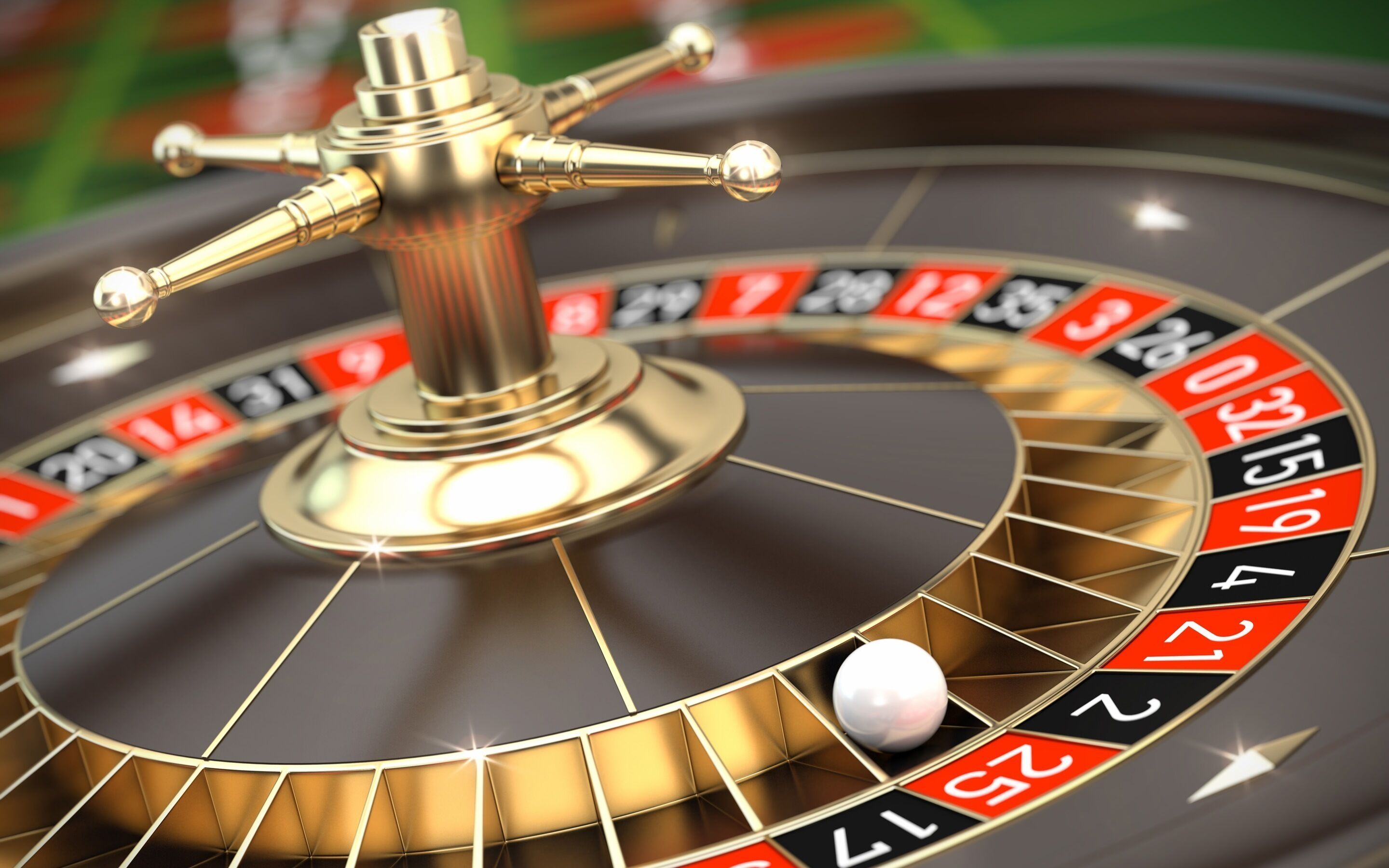 A roulette wheel with a golden handle and numbered slots.