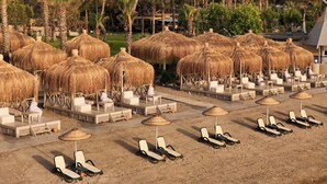 A beachside resort with thatched umbrellas and sun loungers. - Balmy Foresta - All inclusive (Kemer)
