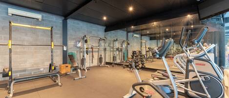 A gym with various exercise equipment, including treadmills and weight machines.