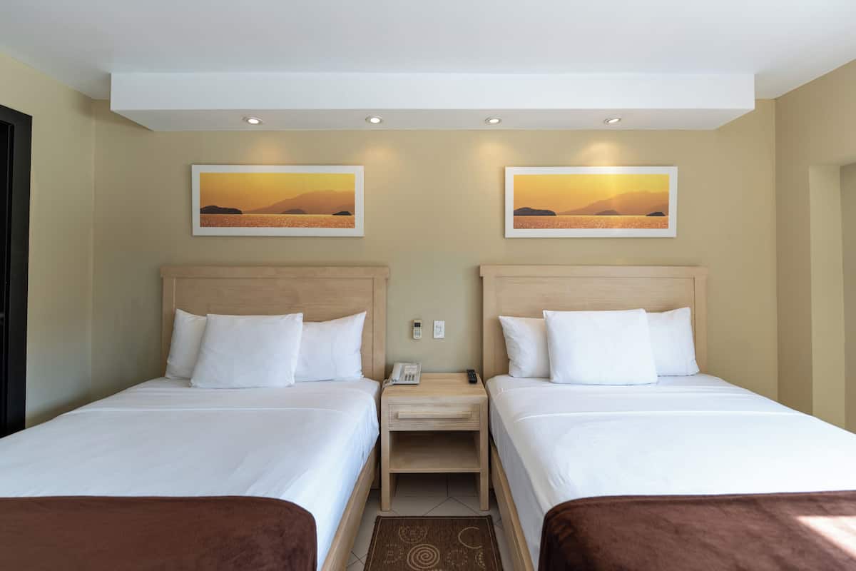 Standard Room, Multiple Beds | Premium bedding, in-room safe, desk, blackout drapes
