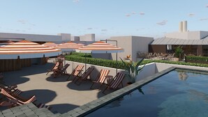 A rooftop pool area with lounge chairs and striped umbrellas. - Palacio San Juan, A Royal Hideaway Hotel (Murcia)