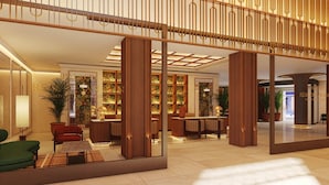 A modern hotel lobby with a central seating area, a reception desk, and a large mirror reflecting the space. - Palacio San Juan, A Royal Hideaway Hotel (Murcia)