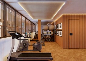 Un gimnasio moderno con equipo de ejercicio, paredes de madera y un patrón de suelo en espiga.