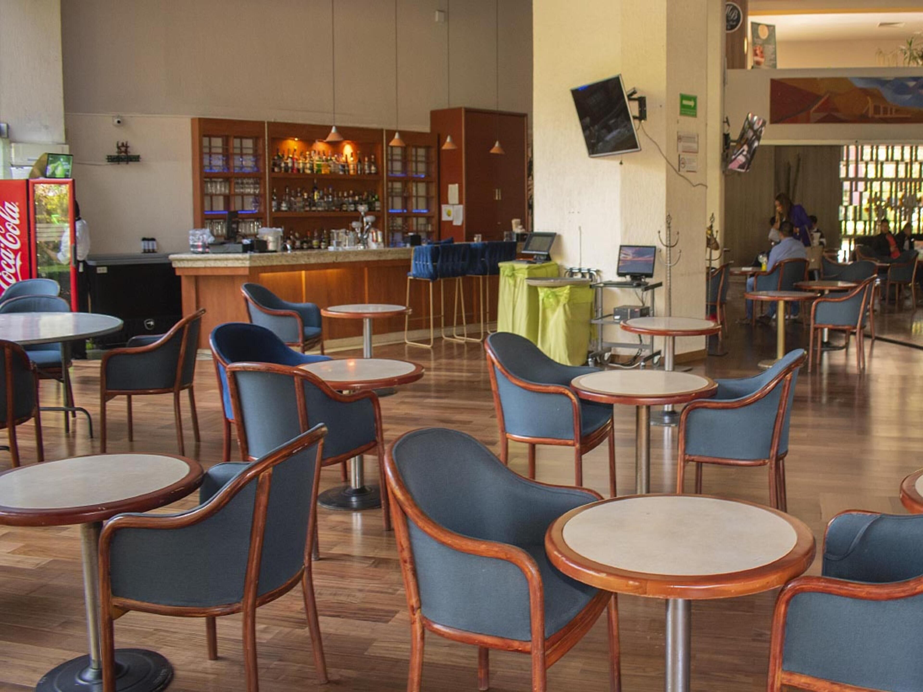 A bar area with wooden furniture and a bar counter.