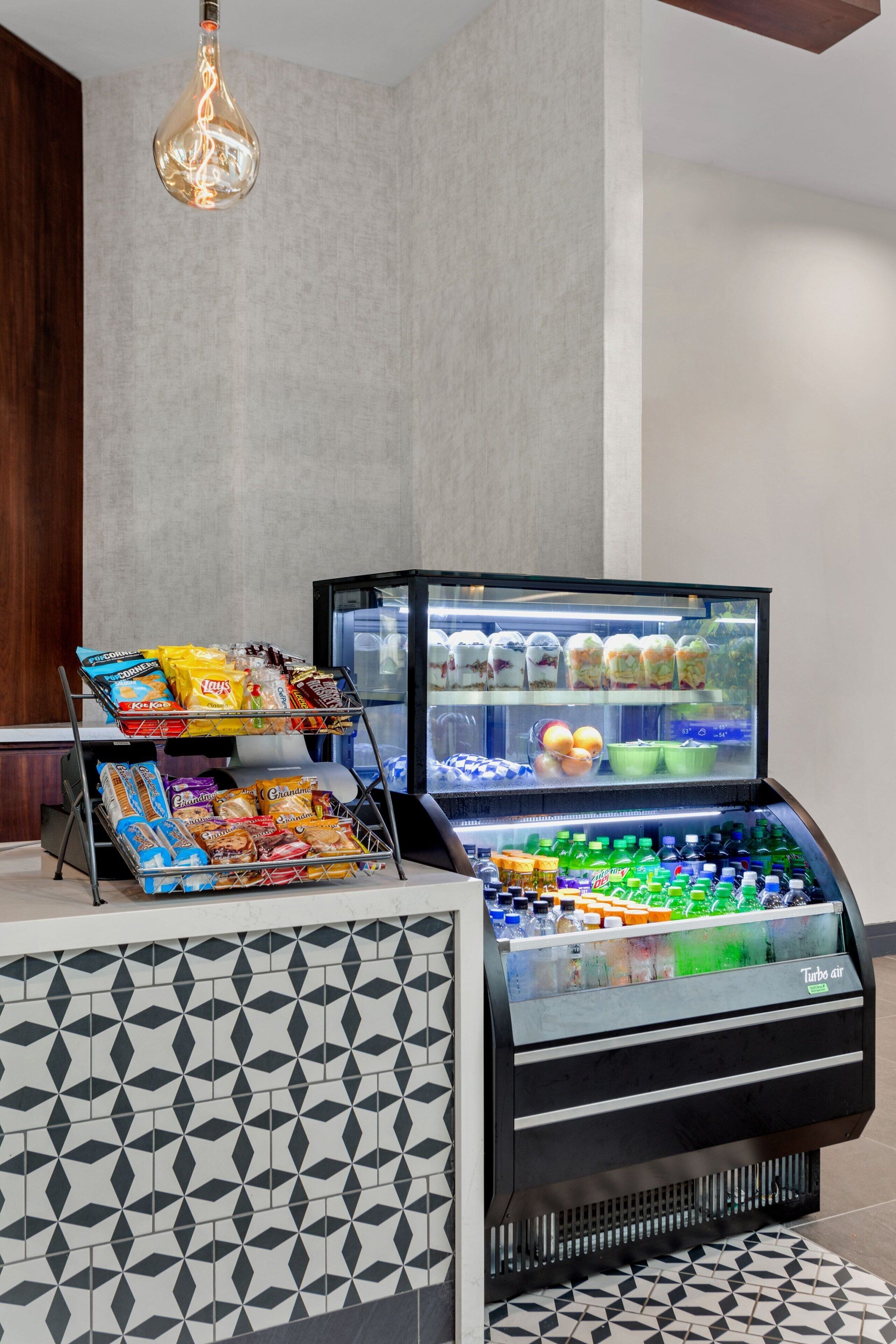 A self-service beverage station with a variety of drinks and snacks.