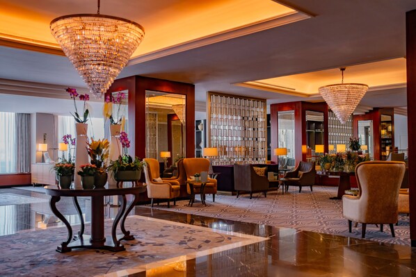Relax in style with comfortable seating and a grand chandelier in our elegant lobby.