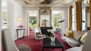 A luxurious room with a fireplace, elegant furniture, and a chandelier. - Château Belmont Tours by The Crest Collection (Tours)