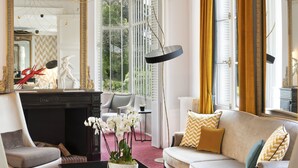 A luxurious living room with a chandelier, a sofa, a coffee table, and a large mirror. - Château Belmont Tours by The Crest Collection (Tours)