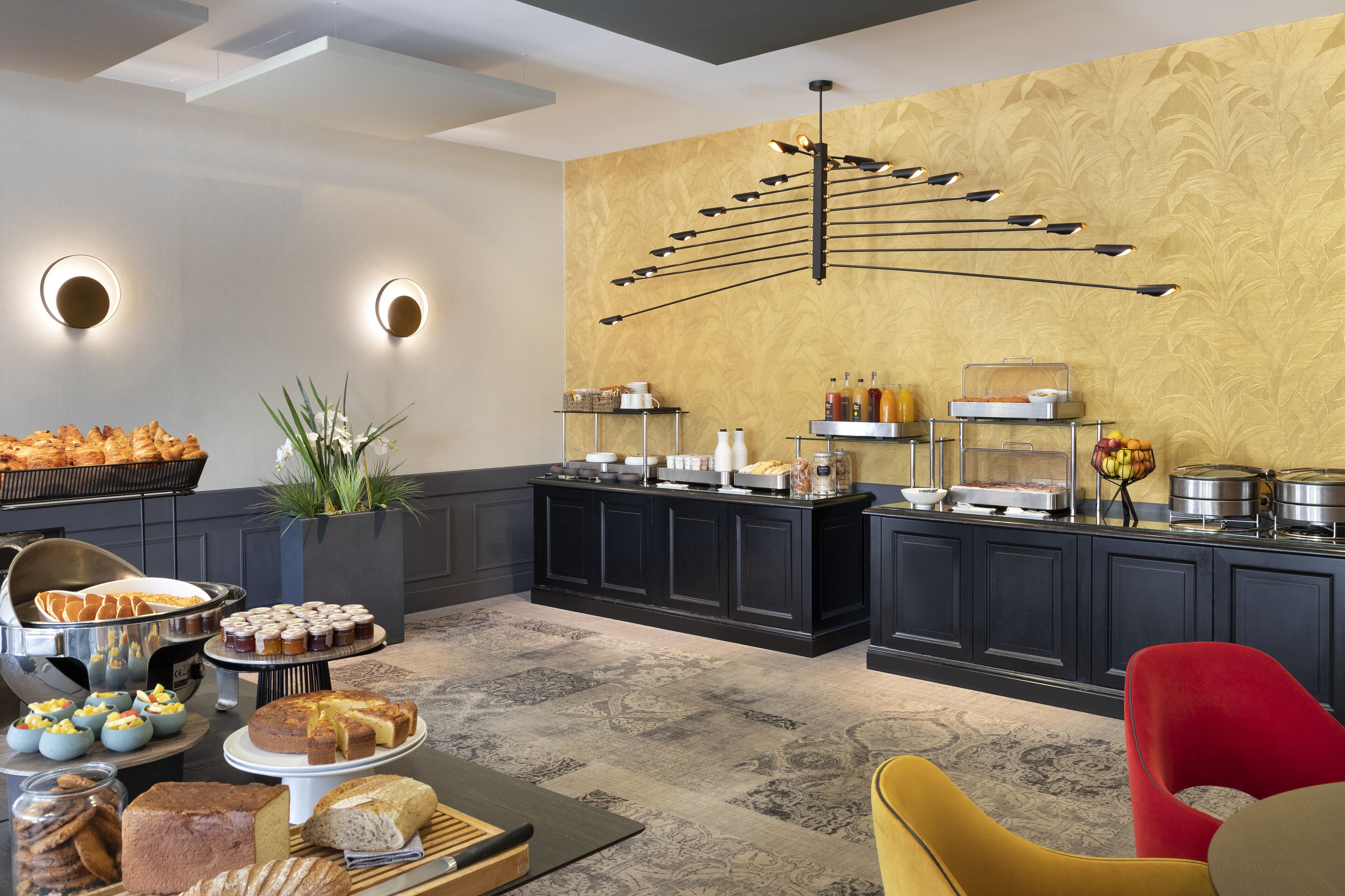 A buffet setup with various food items and a modern interior design.