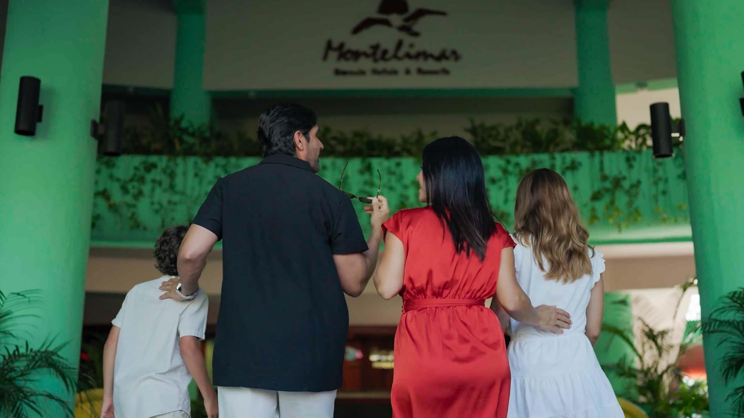 A family of four at the entrance of a hotel named 'Montelimas'.