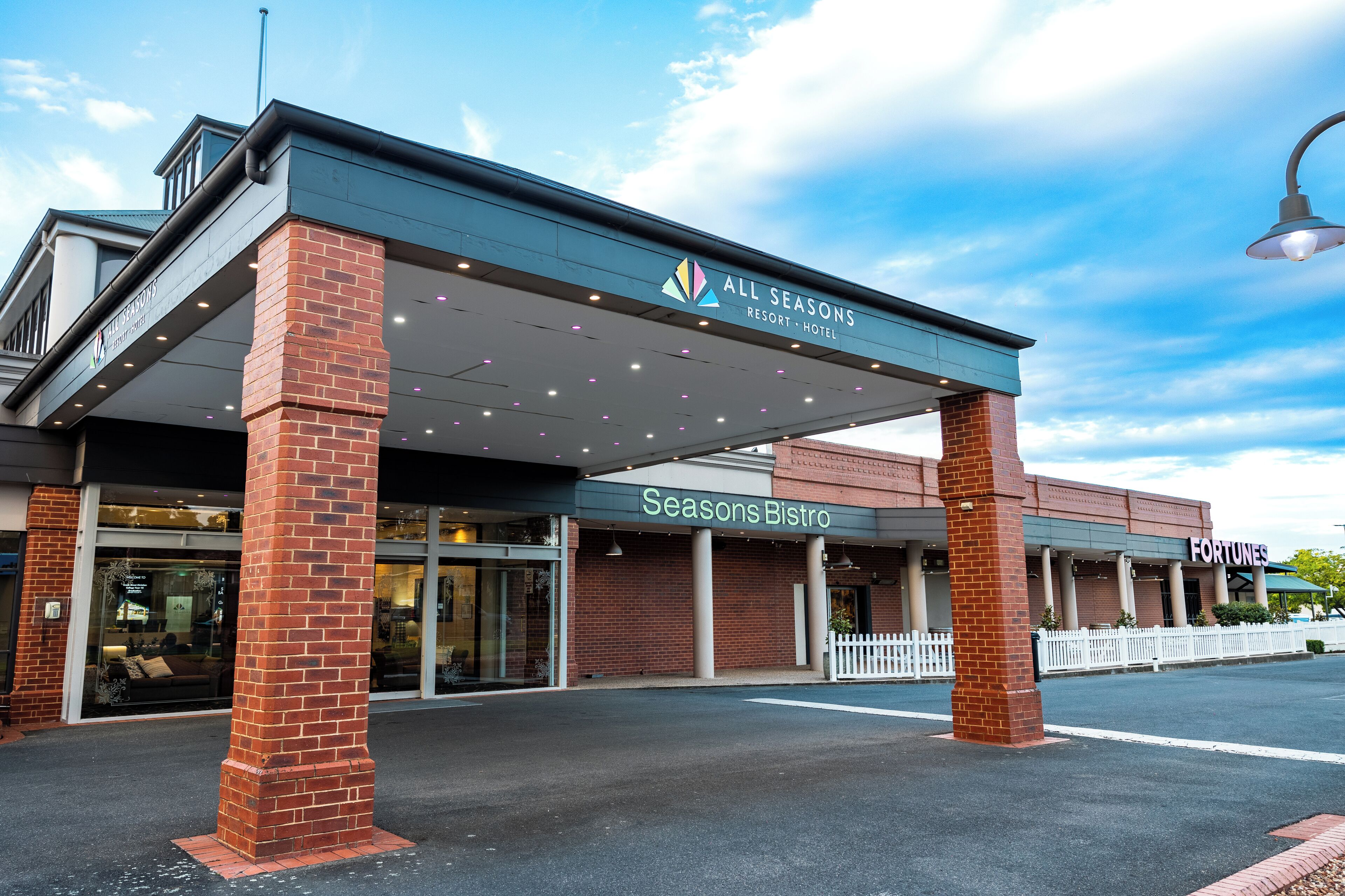 The exterior of All Seasons Resort & Hotel with a Seasons Bistro and a Fortune's sign.
