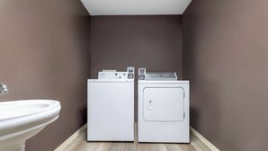 A laundry room with two washing machines and a sink. - Days Inn by Wyndham Anderson IN (Anderson)