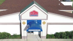 A building with a registration office for Inn at Portland. - Inn at Portland (Portland)