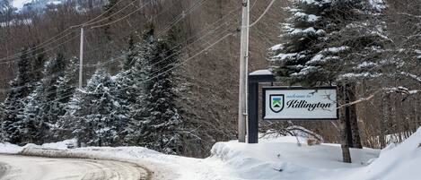 A snow-covered road with a sign reading 'Welcome to Killington.'