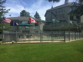 Outdoor pool, a heated pool, open 10:00 AM to 10:00 PM, pool umbrellas