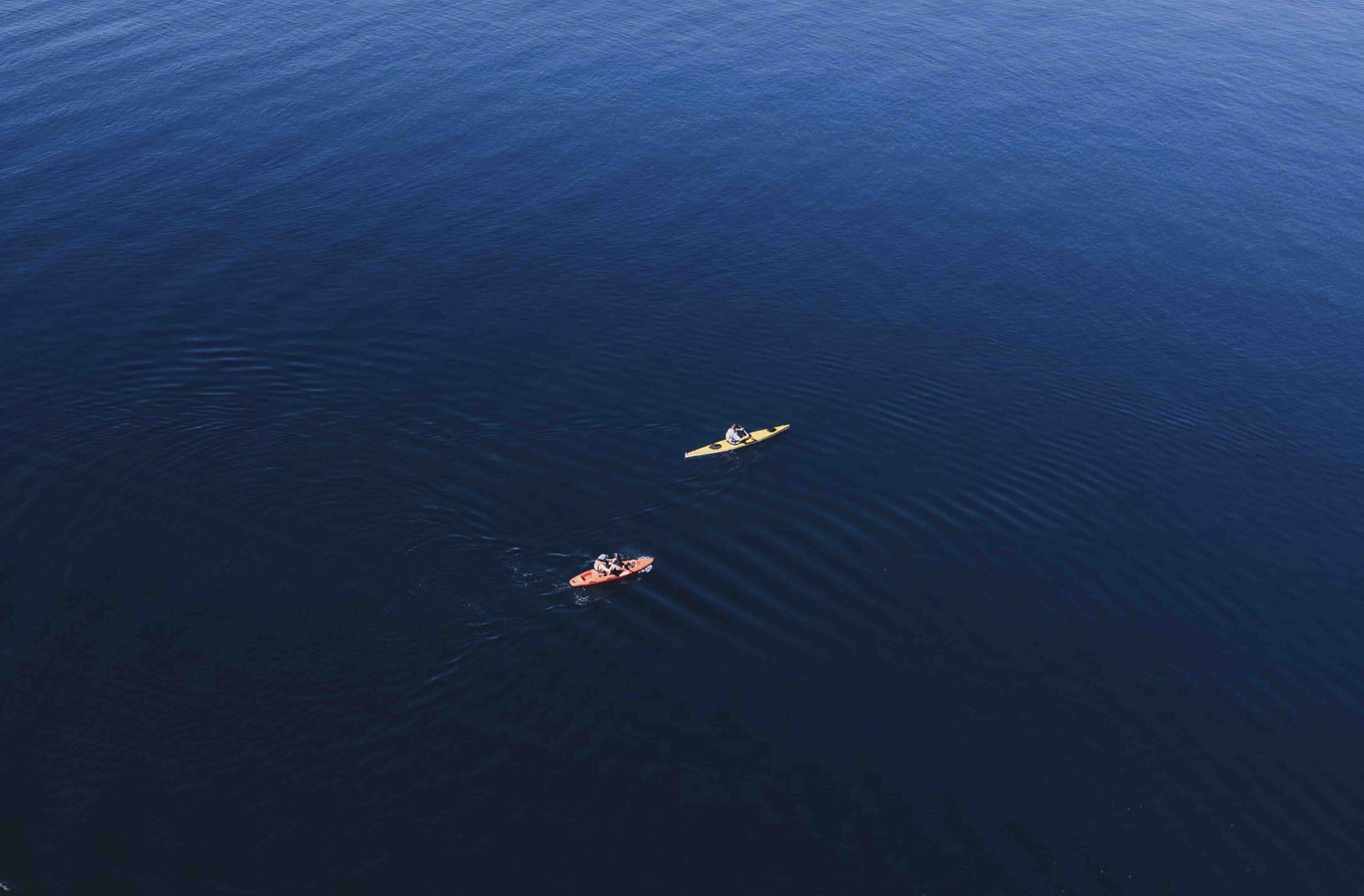 A large body of water with two kayaks.