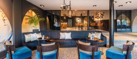 A modern interior with a seating area, a bar, and a large window.