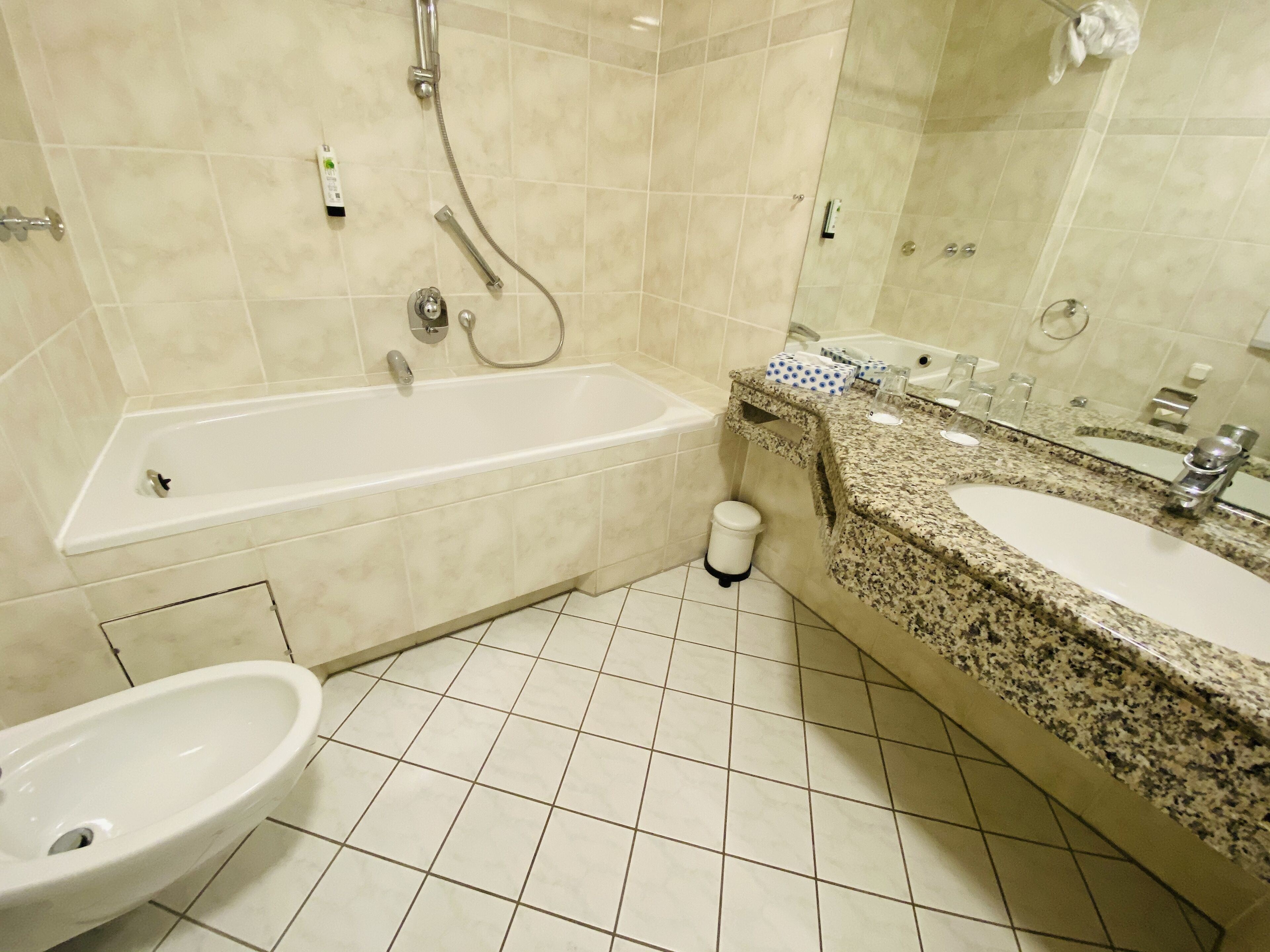 A bathroom with a bathtub, a sink, and a bidet.