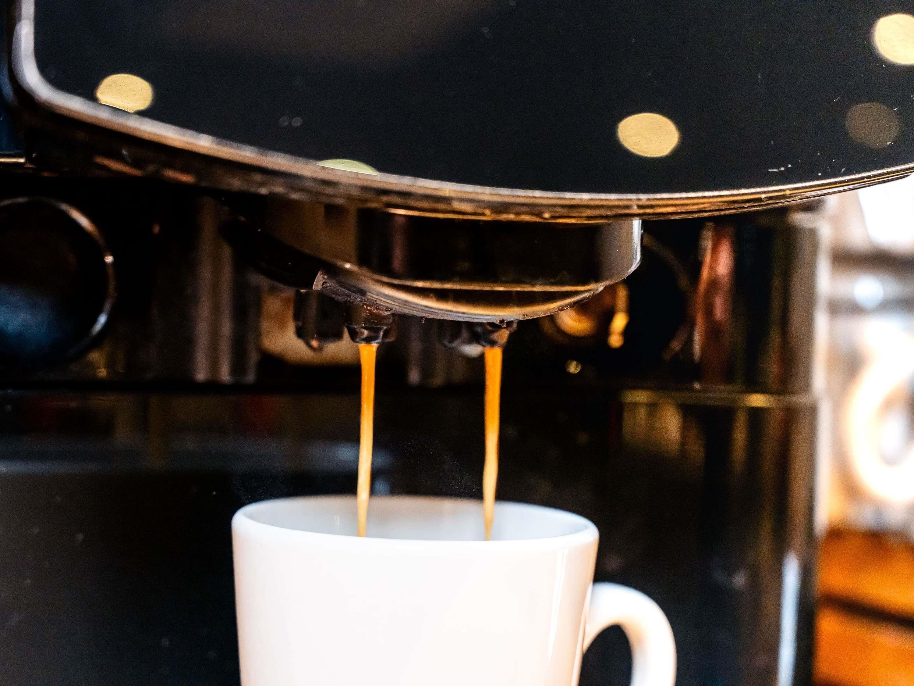 A coffee machine dispensing coffee into a cup.
