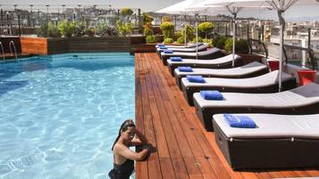 Seasonal outdoor pool, open 10:00 AM to 7:00 PM, pool umbrellas