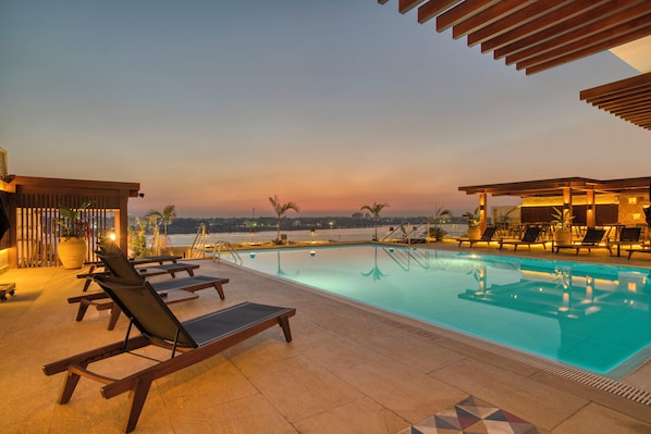 Outdoor pool, open 9:00 AM to 6:00 PM, pool umbrellas