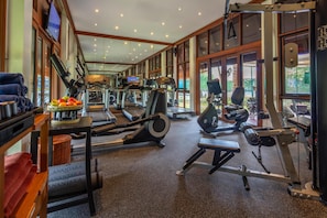 A gym with treadmills, elliptical machines, and weight equipment.