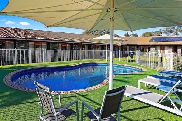 Outdoor pool, open 9:00 AM to 9:00 PM, pool umbrellas, pool loungers