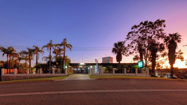 Welcome to our hotel, where a beautifully landscaped entrance sets the tone for a relaxing stay.
