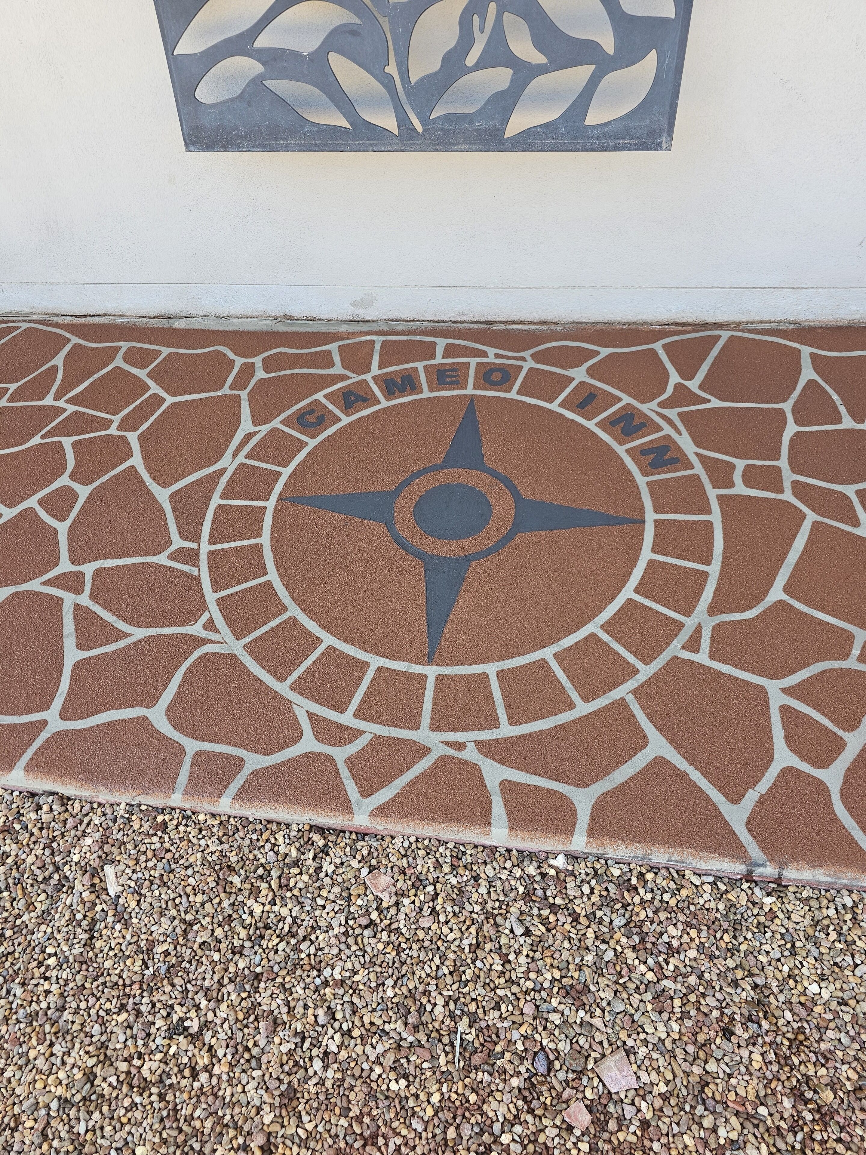 A mosaic floor with a compass design and the word "CAMEO" in the center.