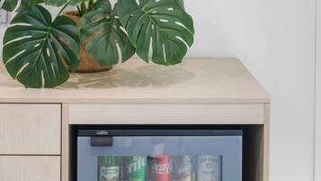 A minibar with a plant and beverages.