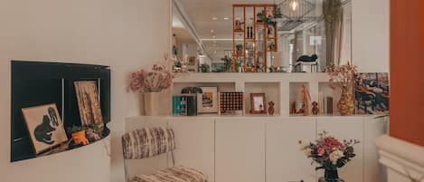 A modern living room with a sofa, a coffee table, and a bookshelf.