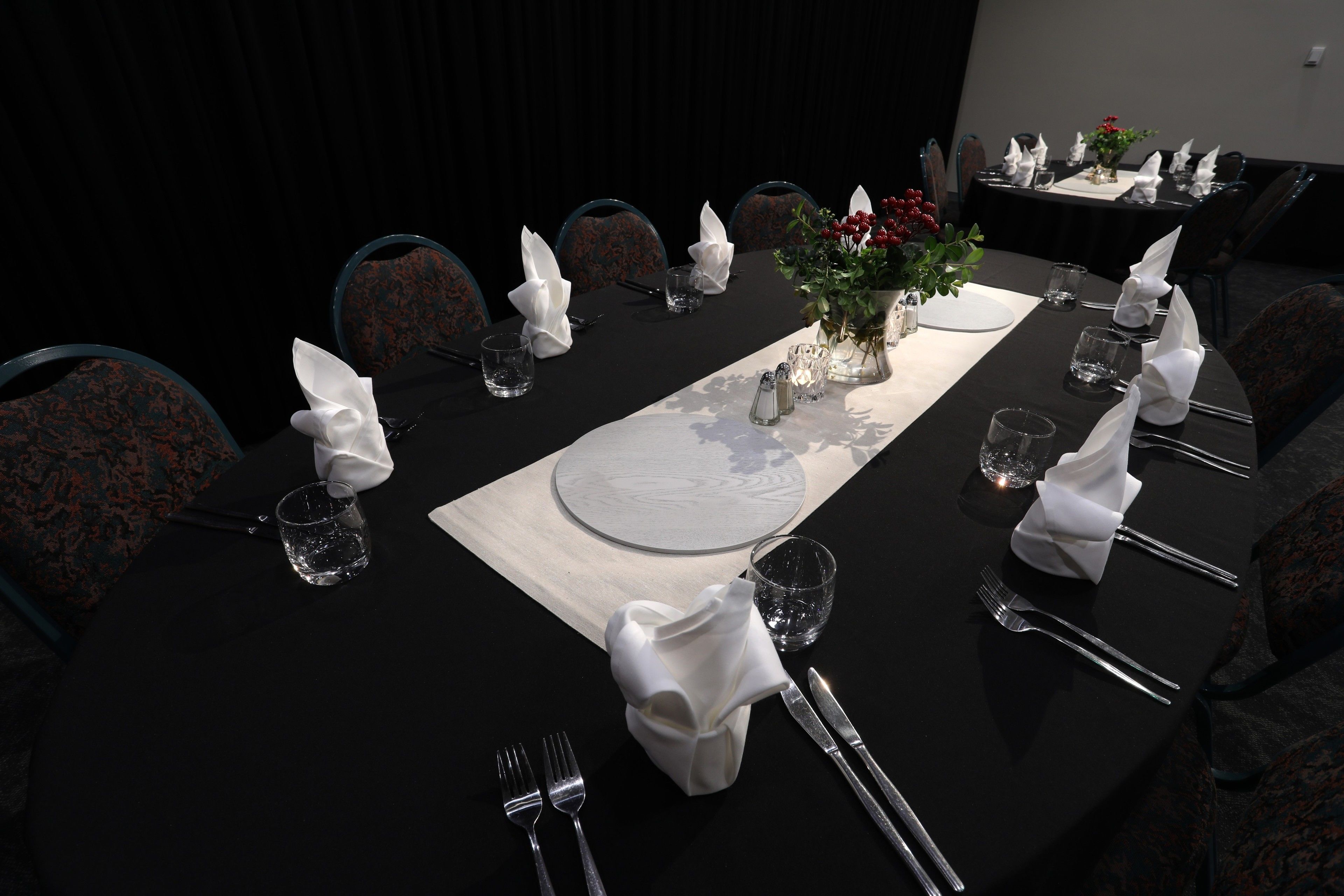 A conference room with a long table set for a meeting.