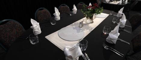 A conference room with a long table set for a meeting.