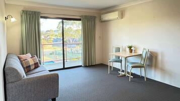 Suite, 1 King Bed, Non Smoking | Premium bedding, blackout drapes, iron/ironing board, free WiFi