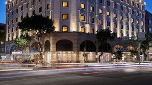 A multi-story hotel with a symmetrical facade, large windows, and a prominent entrance with a decorative arch. - The Riviera Hotel (Taipei)
