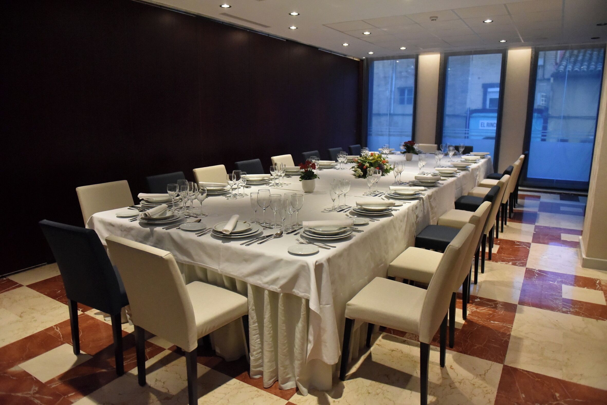 A conference room with a long table set for a meeting.