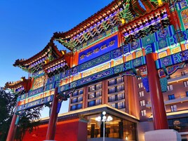 A traditional building with ornate architecture, large columns, and a well-lit facade.
