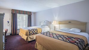 A hotel room with two beds, a desk, a chair, a telephone, and a window with curtains. - Motel 6 London, KY (London)