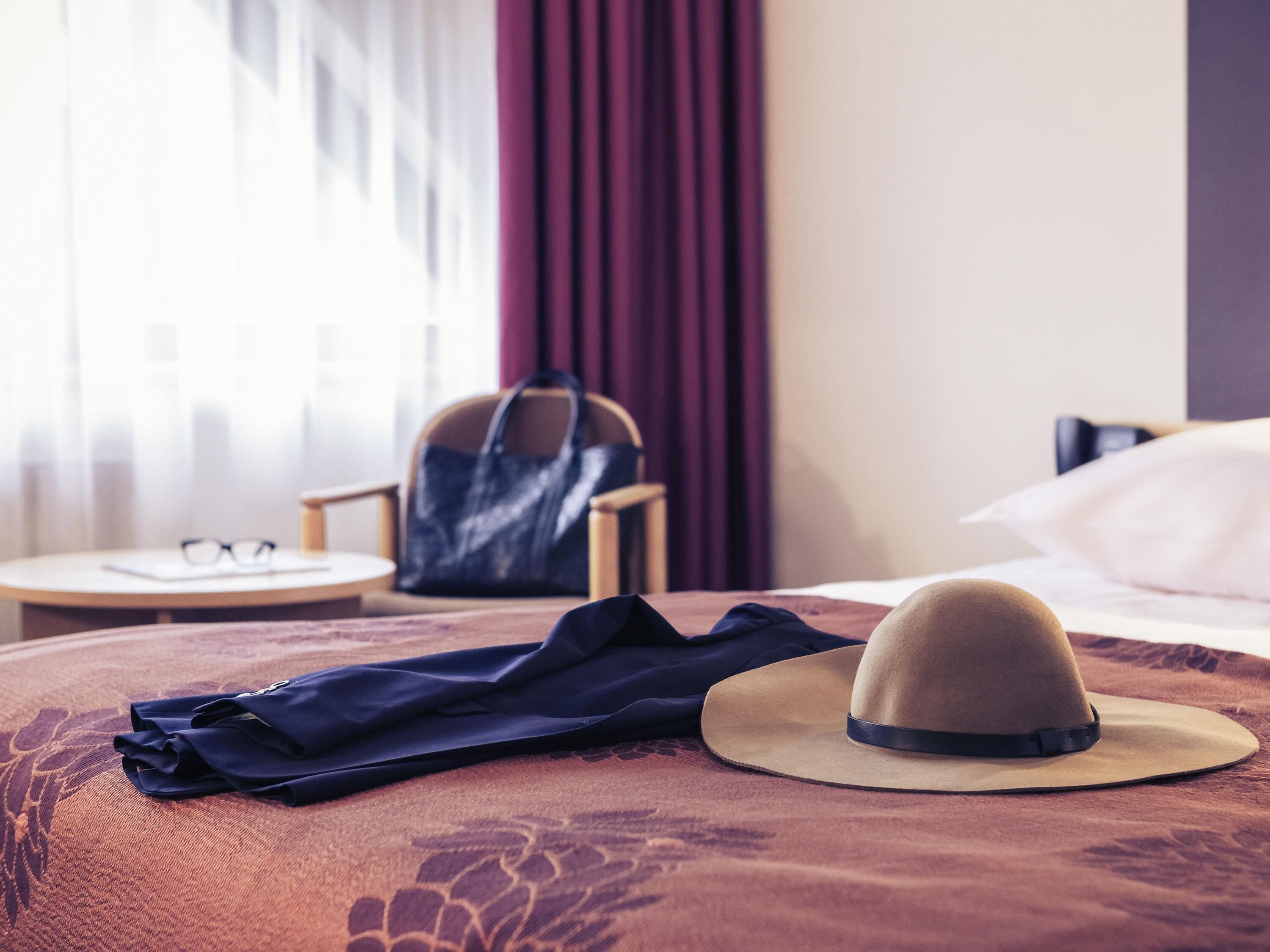 Hypo-allergenic bedding, desk, laptop workspace, blackout curtains