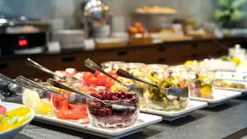 A buffet with various food items and utensils.